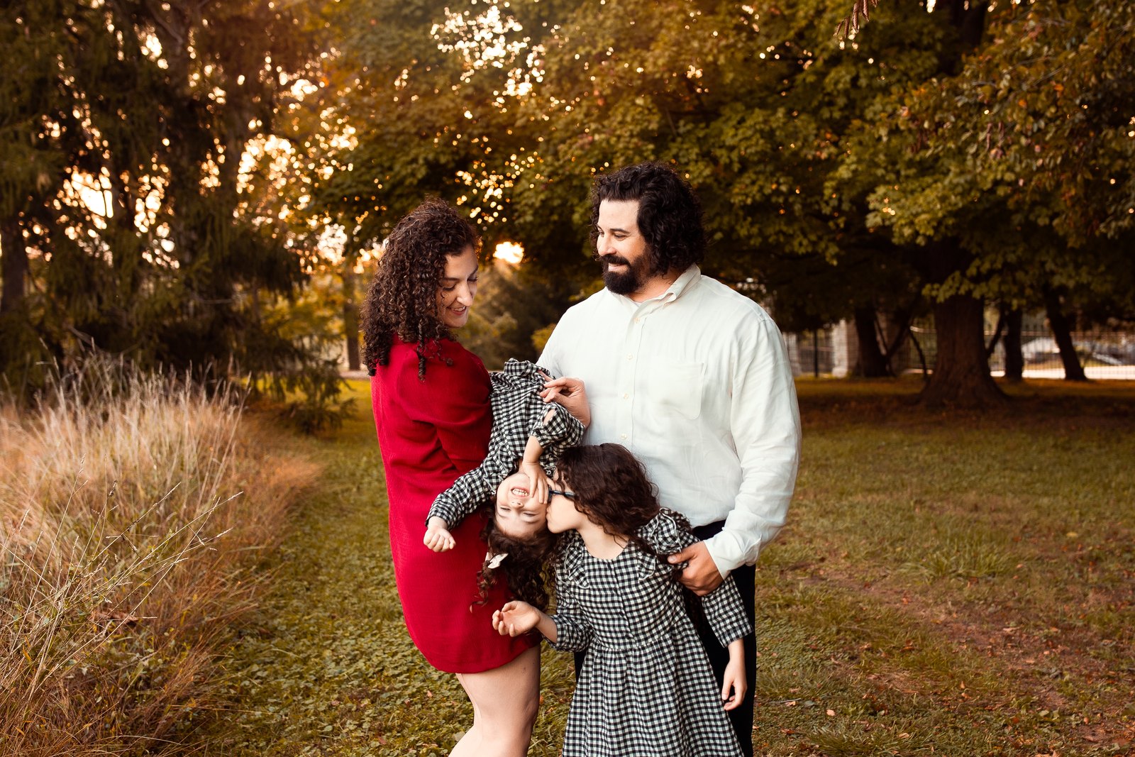 Parents with their three children during an outdoor family photography session in Timonium, Maryland