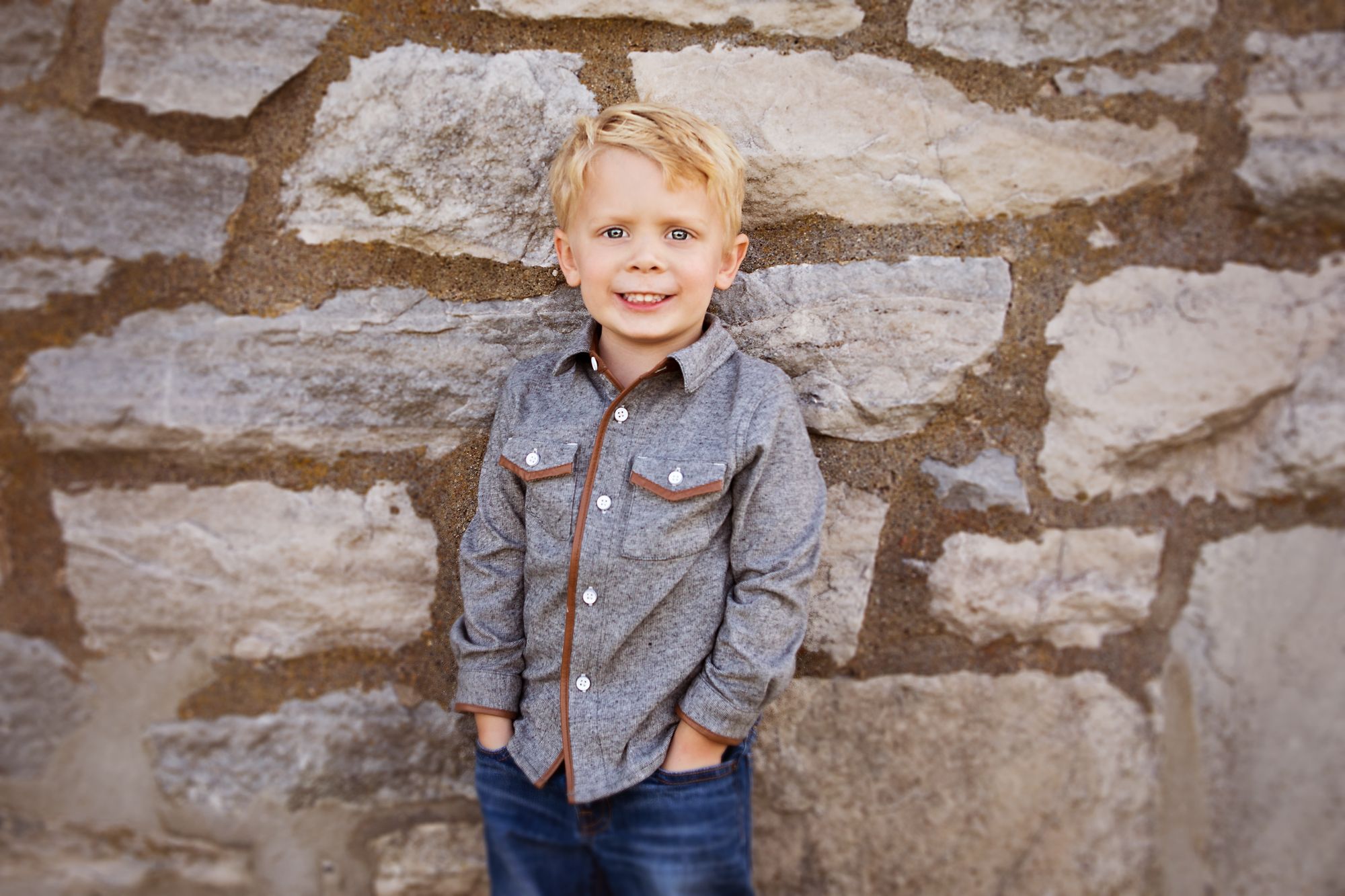 Child posing in front of the wall