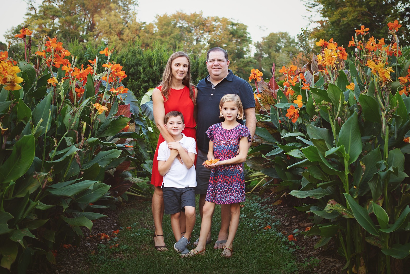 Family of Four between Canna Flowers in Cylburn Arboretum