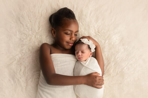 Sibling holding newborn