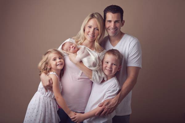 Annapolis parents holding their newborn during studio portrait session