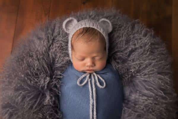 Canton parents holding their newborn during studio portrait session