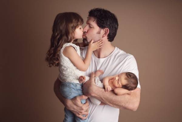 Columbia MD parents holding their newborn during studio portrait session
