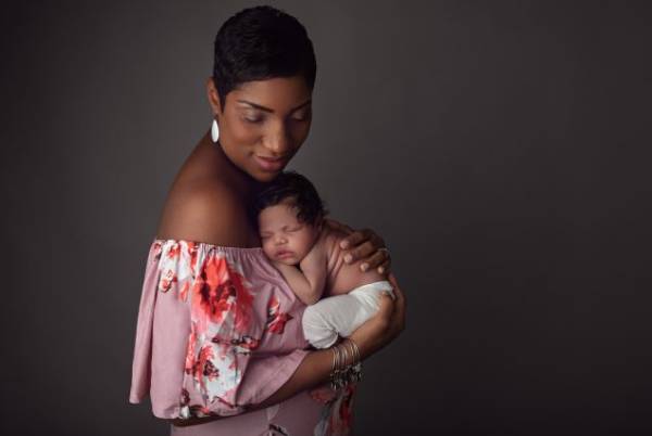Hampden parents holding their newborn during studio portrait session