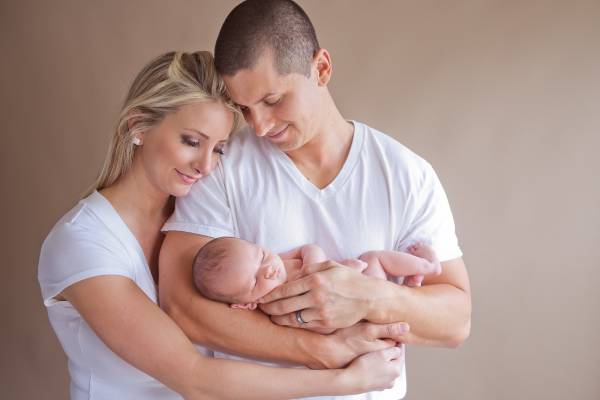 Homeland parents holding their newborn during studio portrait session