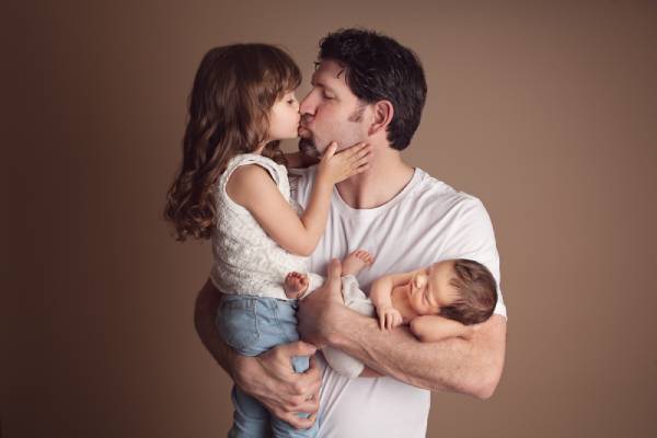 Towson parents holding their newborn during studio portrait session