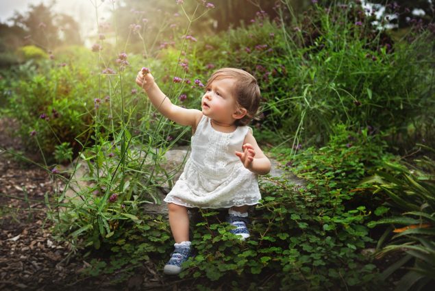 Baby girl holding a flower in Baltimore outdoor session