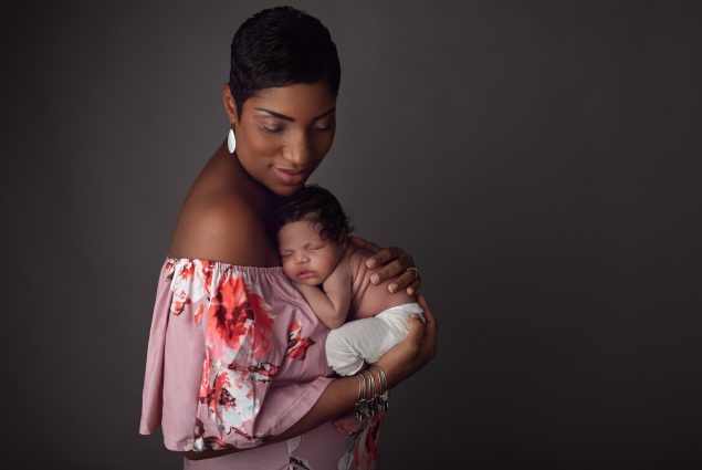Mom holding her newborn in Baltimore studio