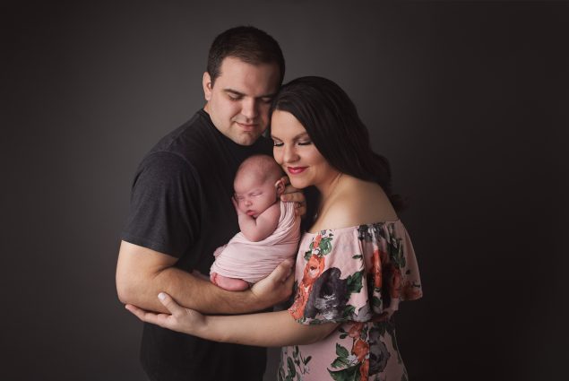 A couple holding their newborn