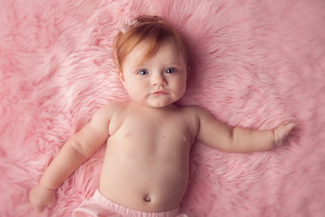 Pink setup with baby girl in milestone session