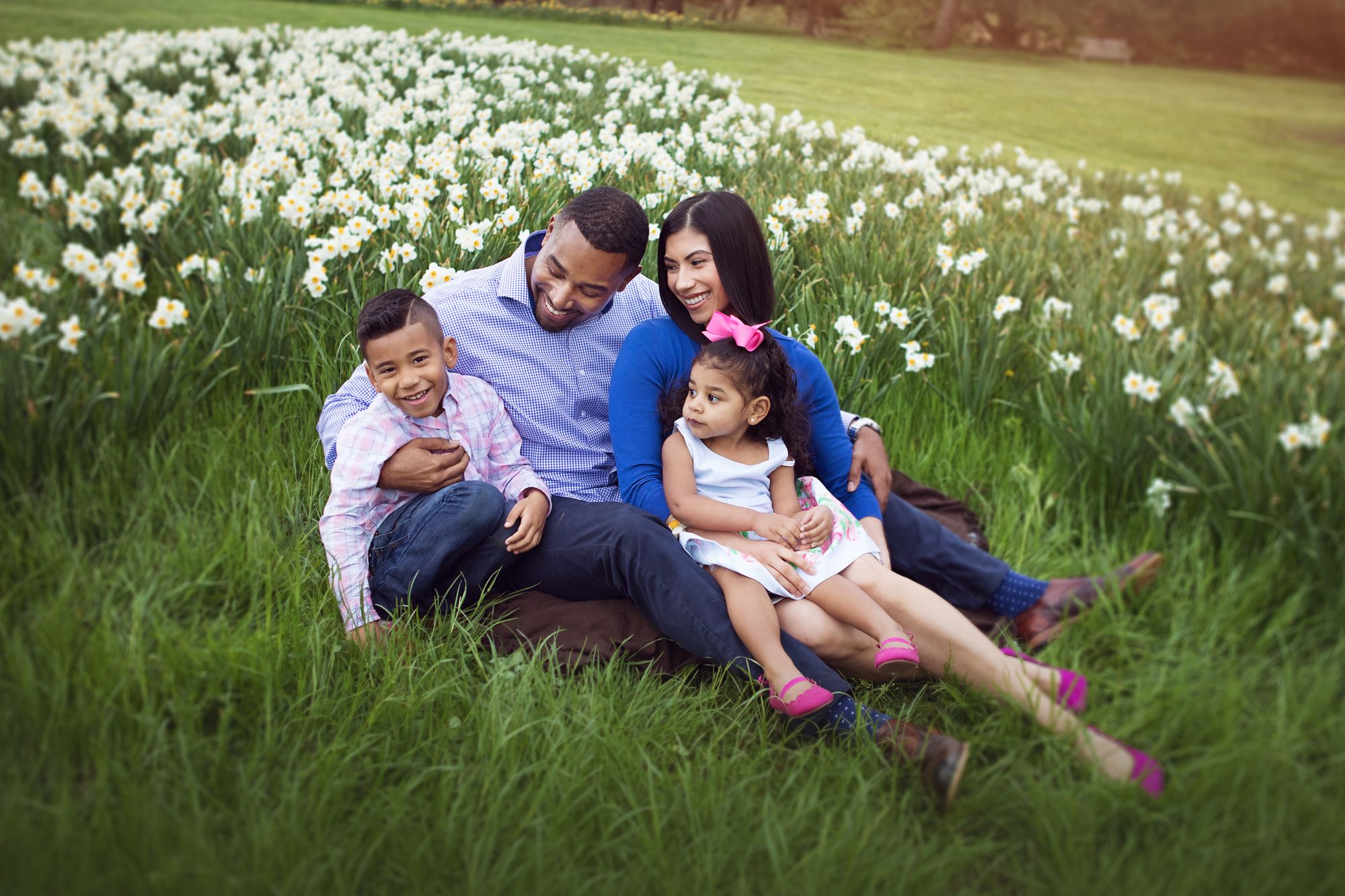 Family smiling in a flower field