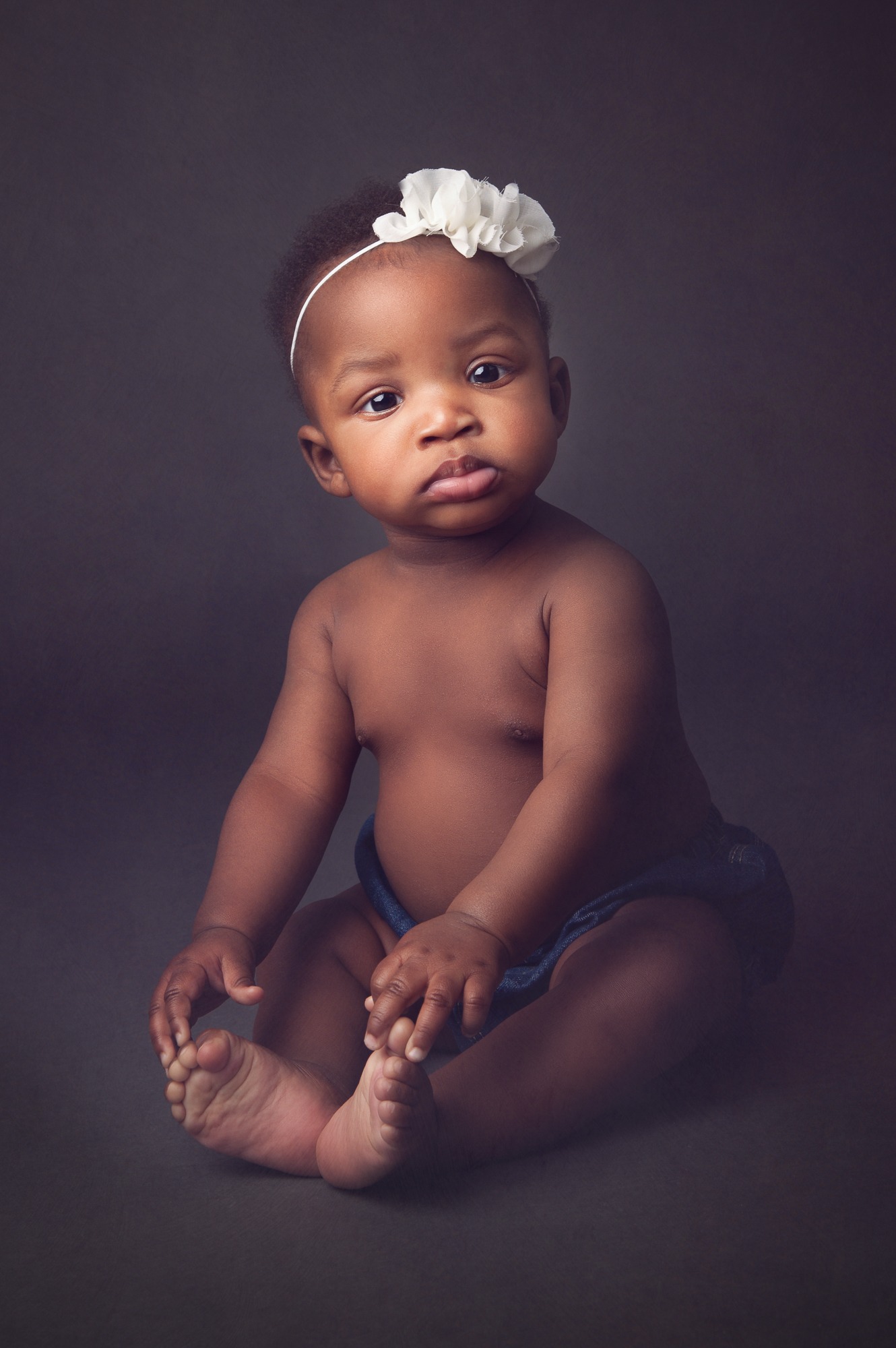 Studio portrait photography session of a curios baby girl