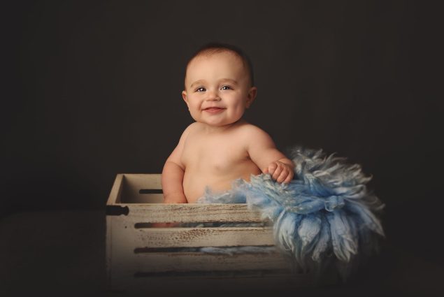 Baby posing in prop crate