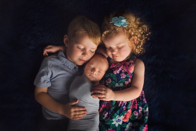 Boy and girl toddlers with newborn