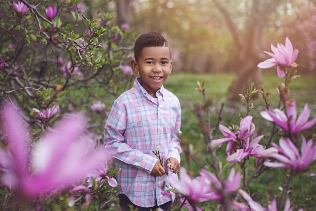 Boy and magnolia trees in an outdoor photography session
