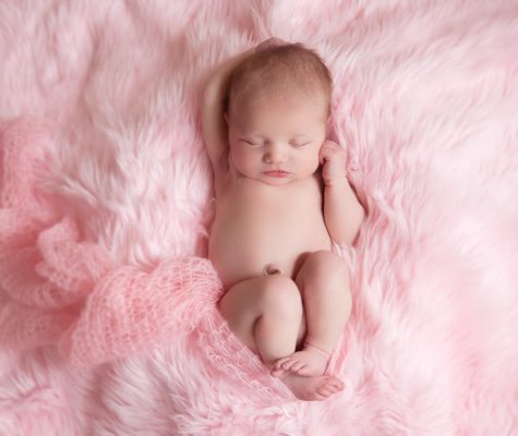 Newborn Girl Sleeping on Pink Blanket