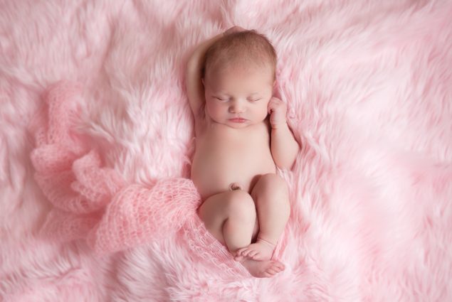 Newborn Girl Sleeping on Pink Blanket