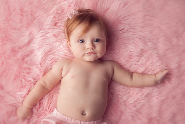 Pink setup with baby girl in milestone session