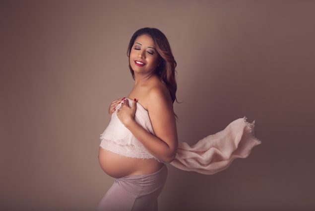 Pregnancy photoshoot in Baltimore, Maryland studio with brown background