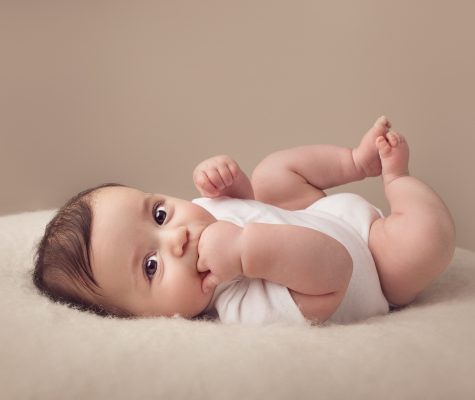 Professional picture of a cute baby boy in white