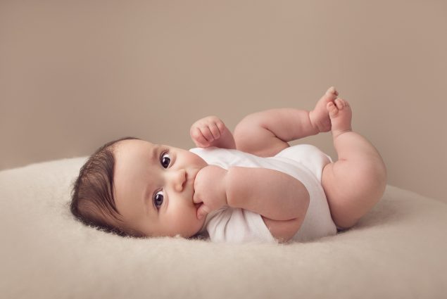 Professional picture of a cute baby boy in white