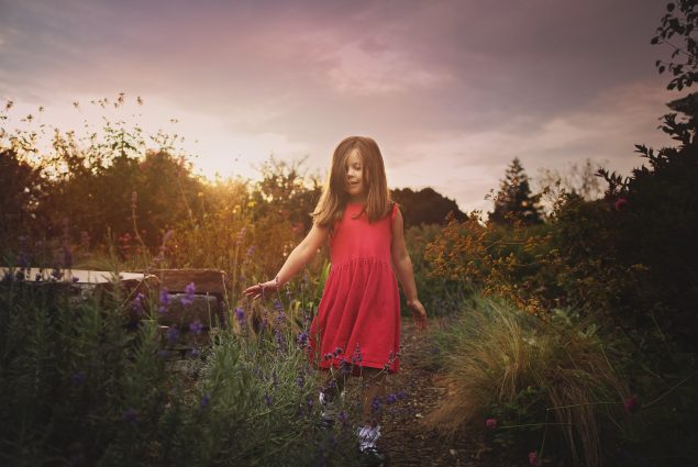Sunset photo of a girl in red dress during nature photography session